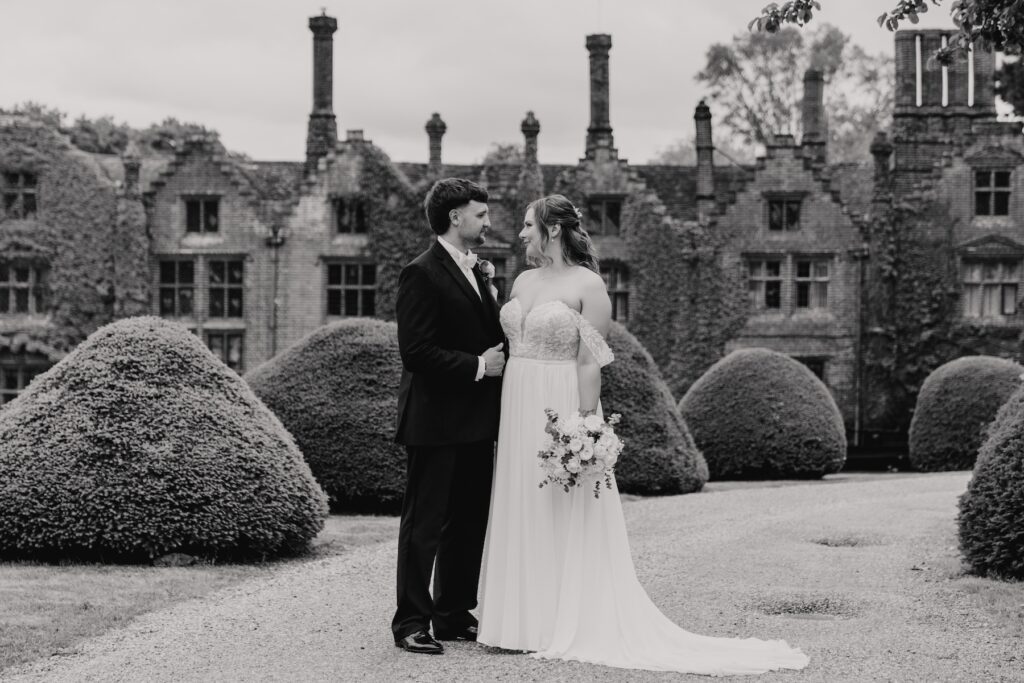 Full-length portrait of newlyweds walking through the gardens