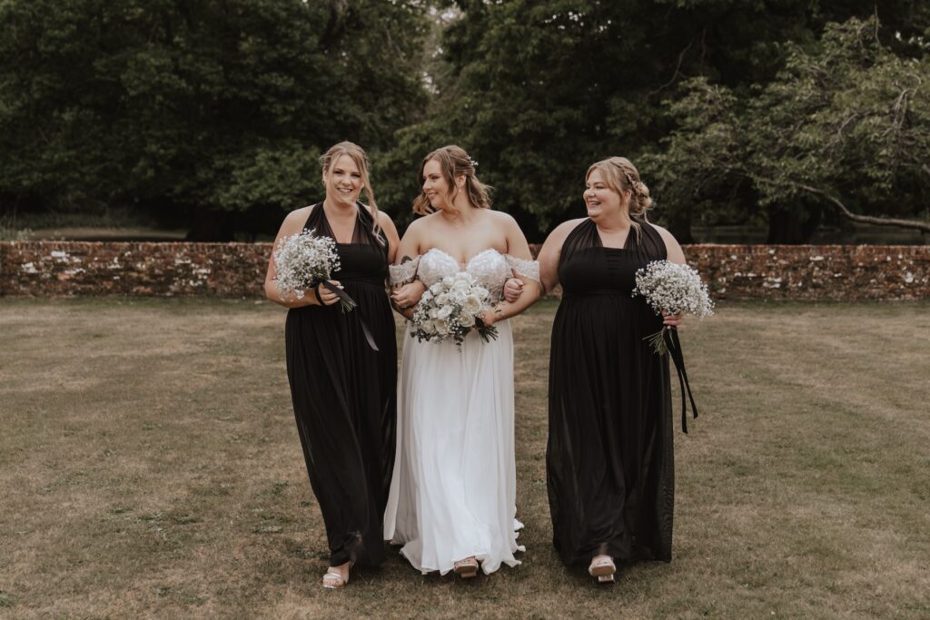 Bridesmaids in matching dresses posing playfully