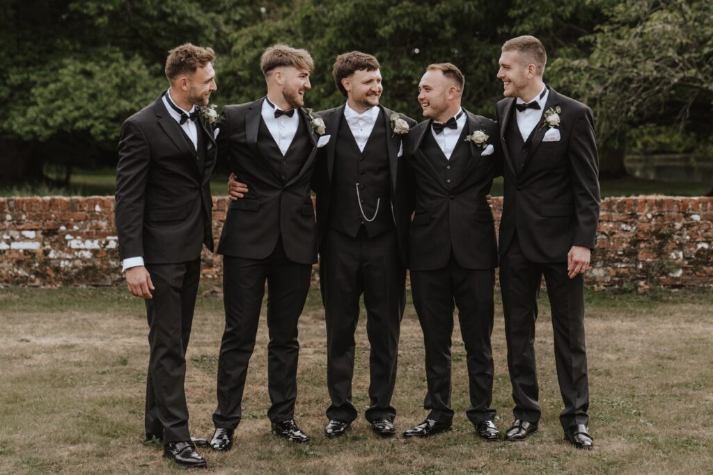 Groom and groomsmen during formal photos at Seckford Hall