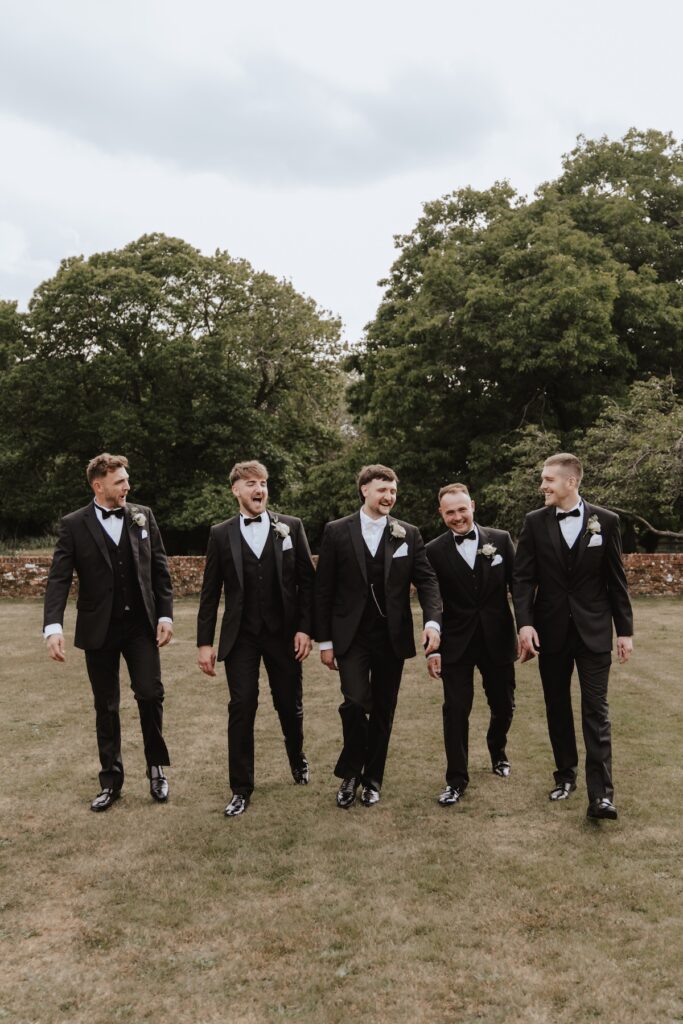Groom looking relaxed in tuxedo before heading to ceremony room