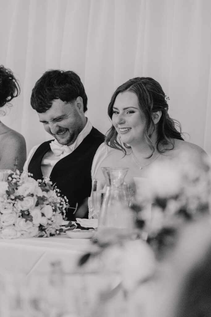 Guests laughing at best man’s speech