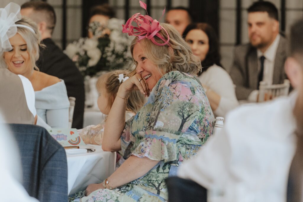 Guests laughing as they listens to heartfelt words during speeches