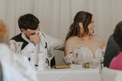 Groom wiping away a tear during emotional speech
