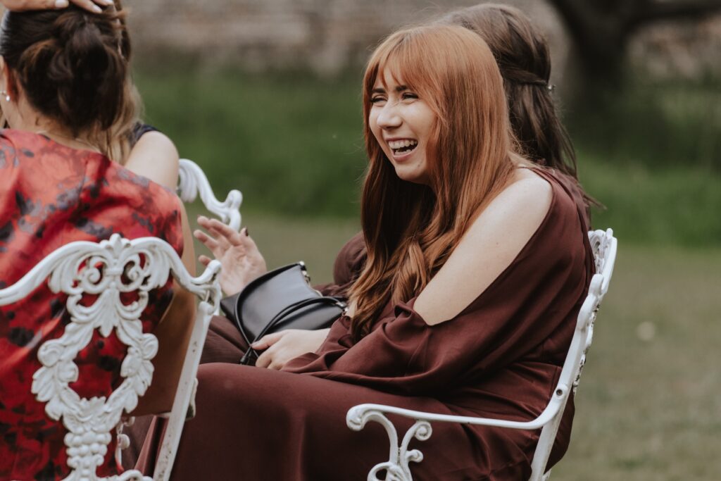 Candids of laughter during evening drinks reception at Seckford Hall