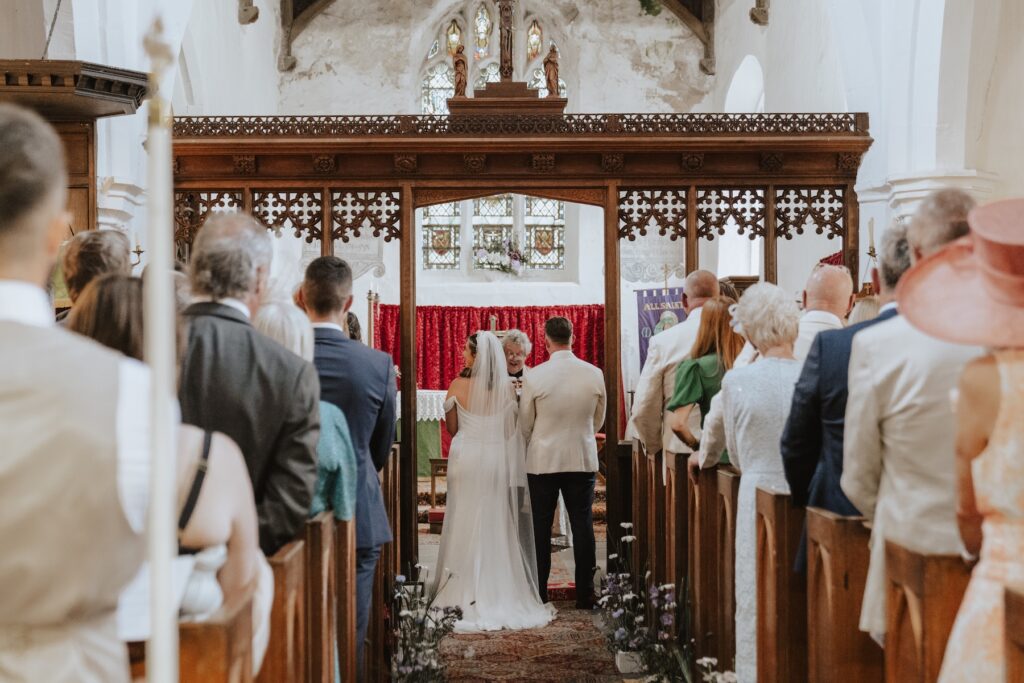 Wide shot of the church interior filled with family and friends