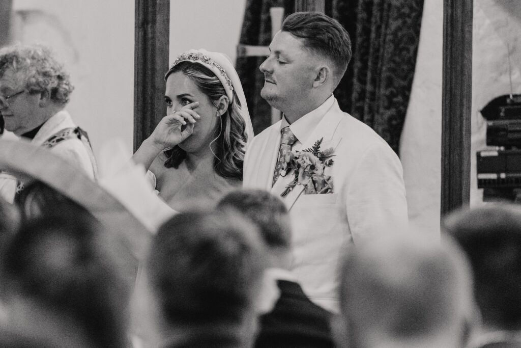 Emotional bride during wedding ceremony at Yorkshire church