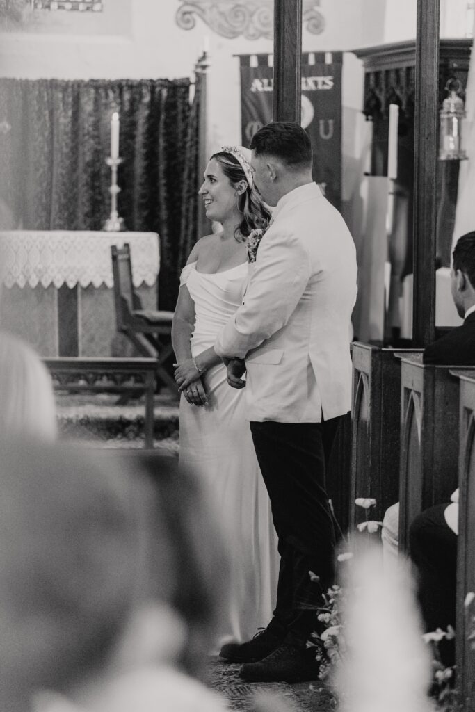 Bride and groom exchanging vows inside a rustic Yorkshire church