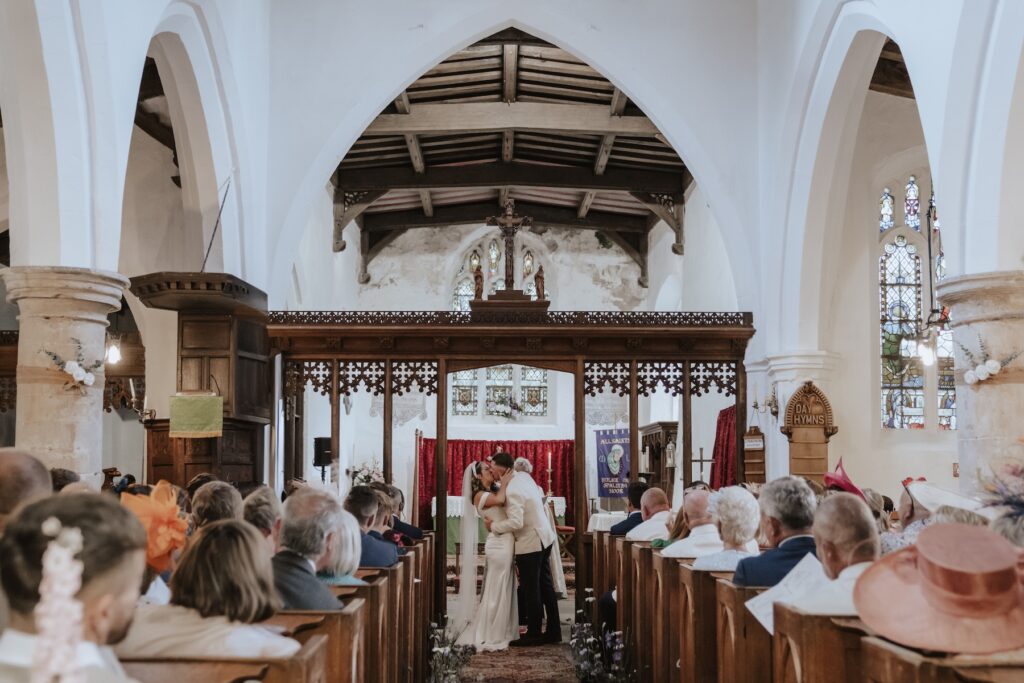 First kiss at Yorkshire church captured by wedding photographer in Yorkshire