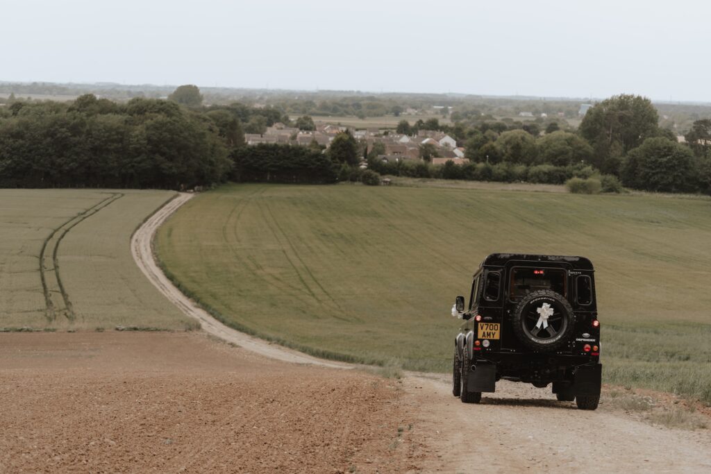 Bride and groom driving down the hill to their reception