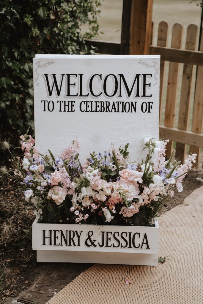 Bride and groom's welcome sign with florals