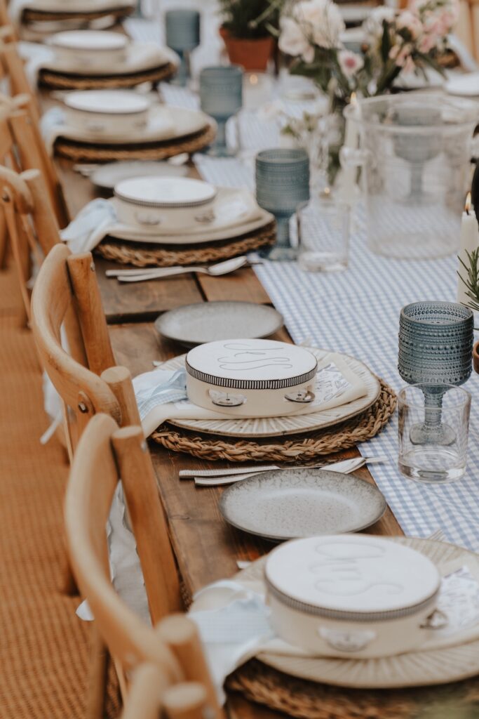 Bride and groom’s table surrounded by candles and greenery