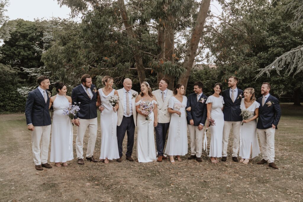 The bride and groom in Yorkshire capturing the wedding party photo