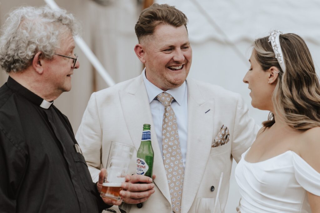 Natural candid photo of guests chatting outside the church