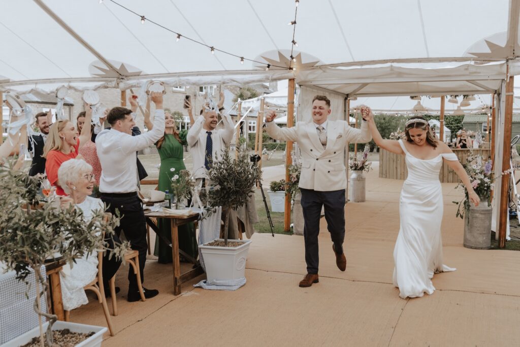 The bride and groom entering their Yorkshire wedding reception