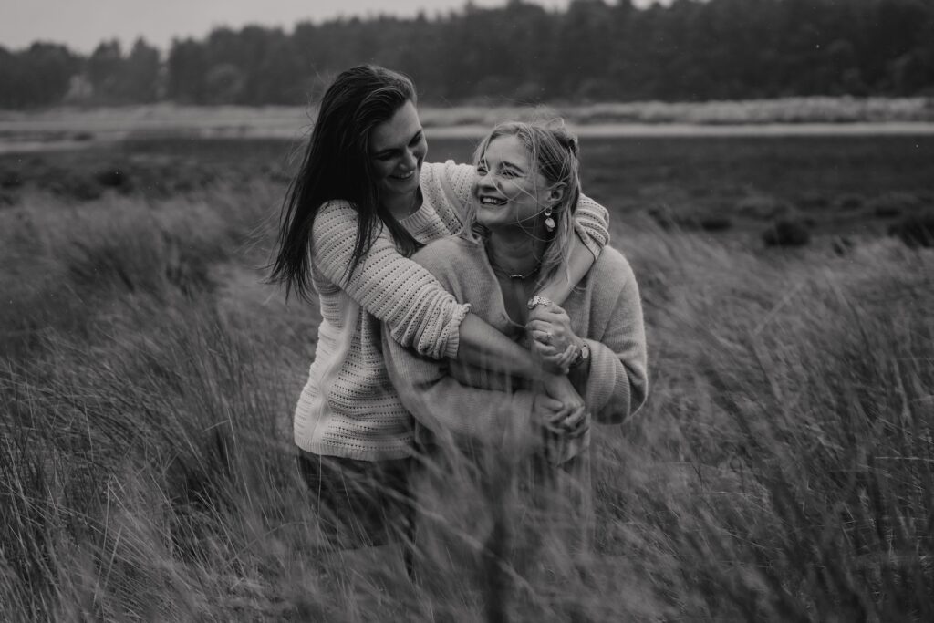 A couple cuddling on Holkham beach during their engagement session