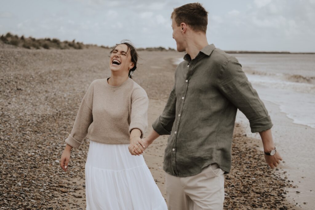Beach couples session of a couple on their engagement session at Southwold in Suffolk