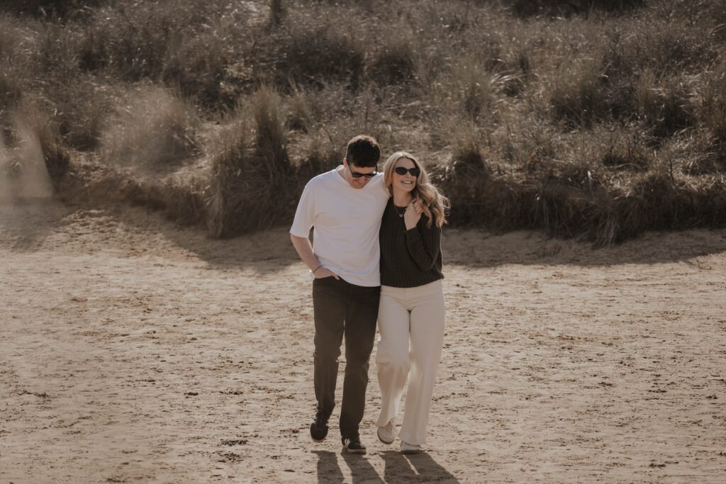 Couple at Norfolk beach during engagement session