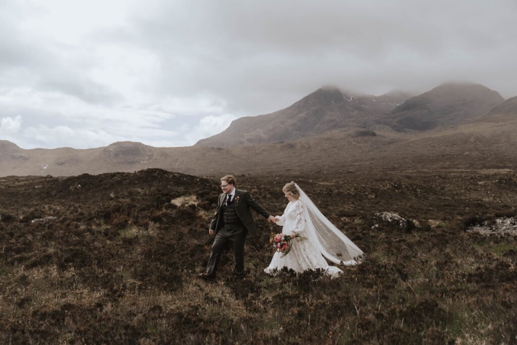 Bride and groom walking through bracken in the Scottish Highlands