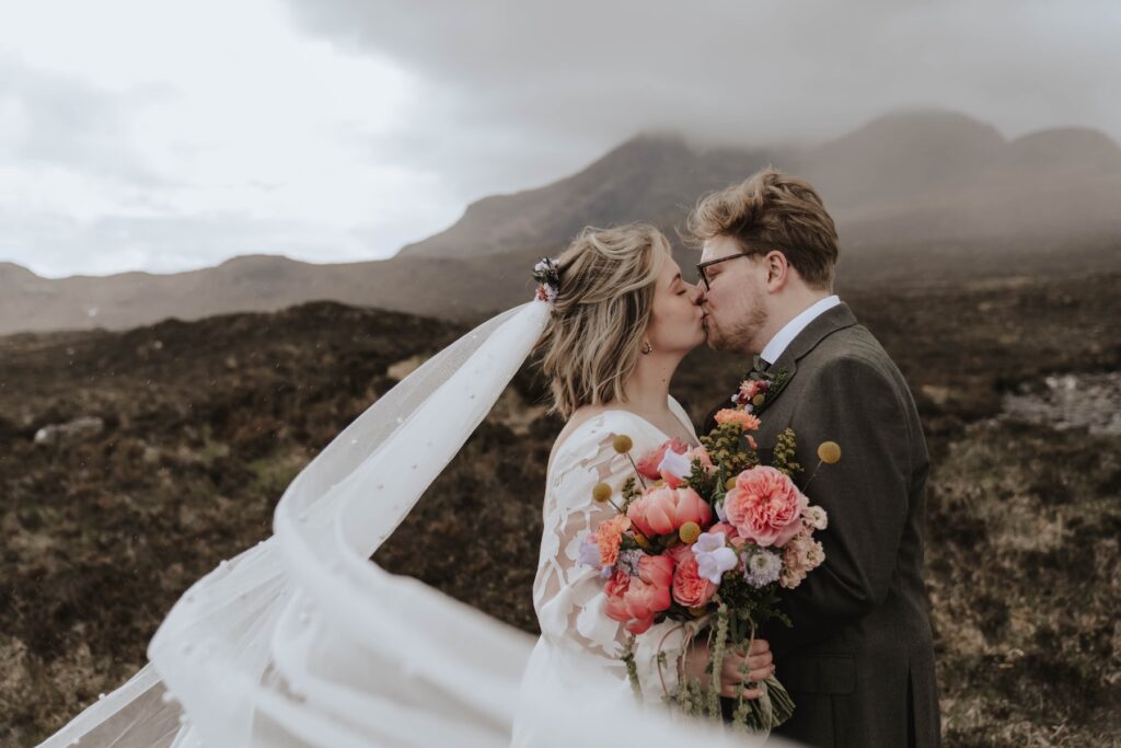 Bride with long veil in Isle of Skye countryside