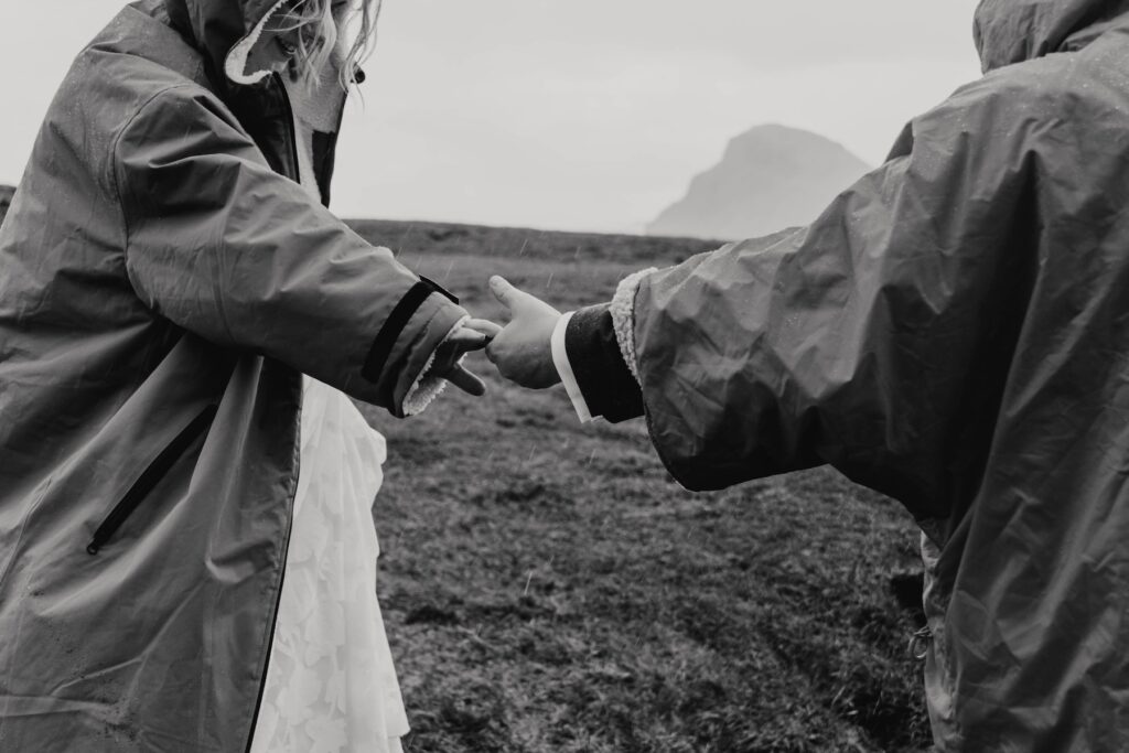 Couple holding hands with mountain views at The Quiraing