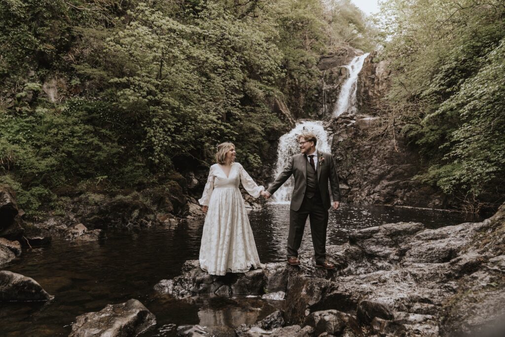 Scotland elopement couple beside secluded Highland waterfall