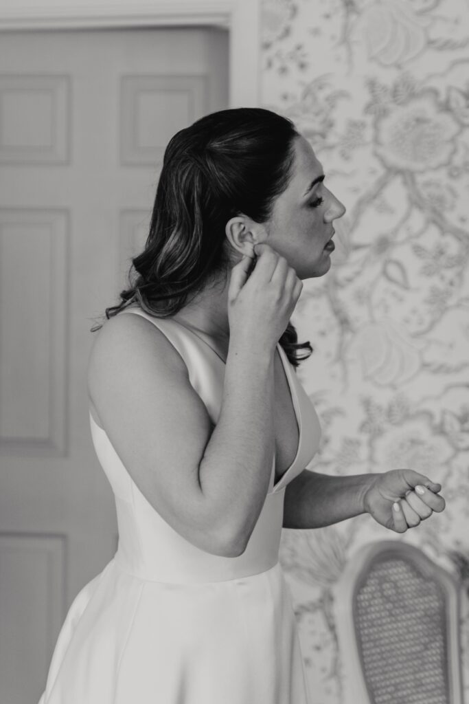 A bride getting into her wedding dress at Seckford Hall