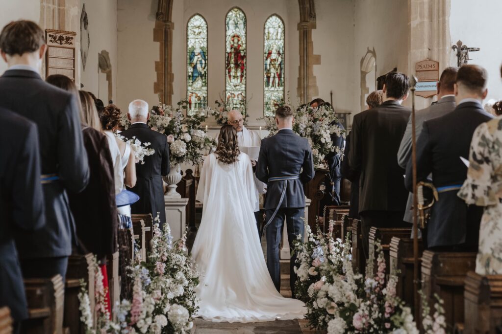 The bride and groom in a Suffolk church on their wedding day