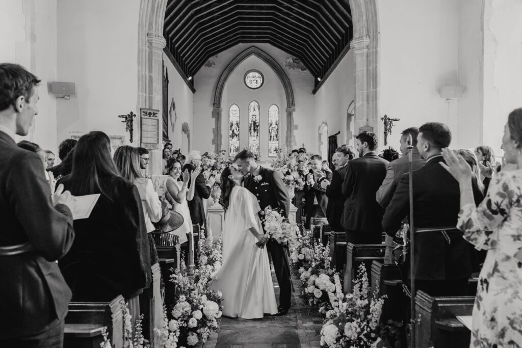 A suffolk church with a bride and groom