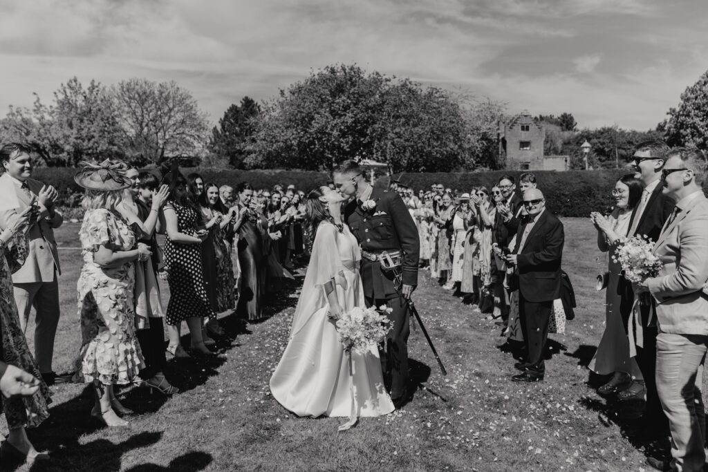 A couple at Seckford Hall having their confetti at their wedding reception