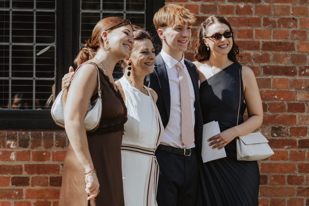 Candid moments of guests during a wedding drinks reception at Seckford Hall in Suffolk