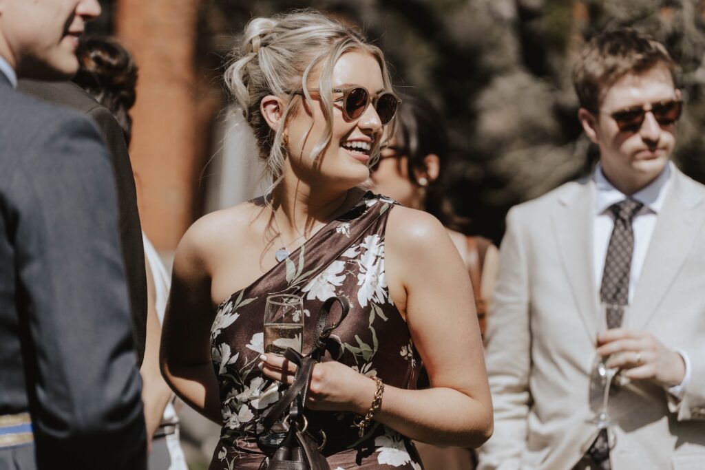 Candid moments of guests during a wedding drinks reception at Seckford Hall in Suffolk