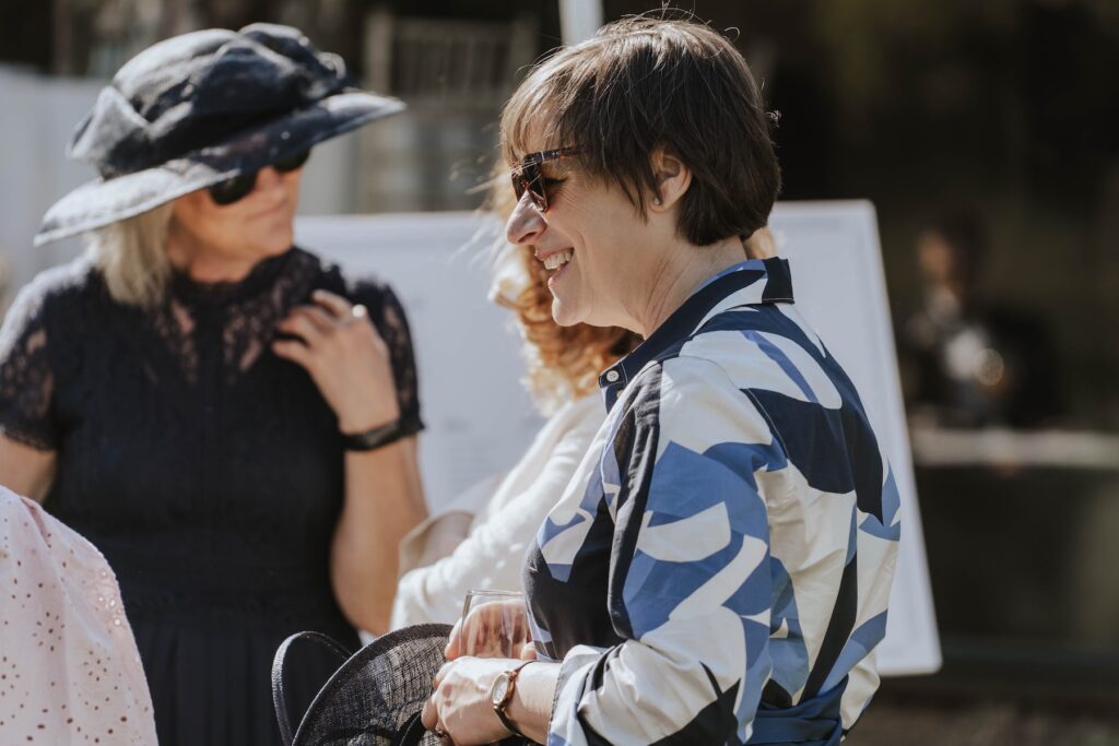 Candid moments of guests during a wedding drinks reception at Seckford Hall in Suffolk