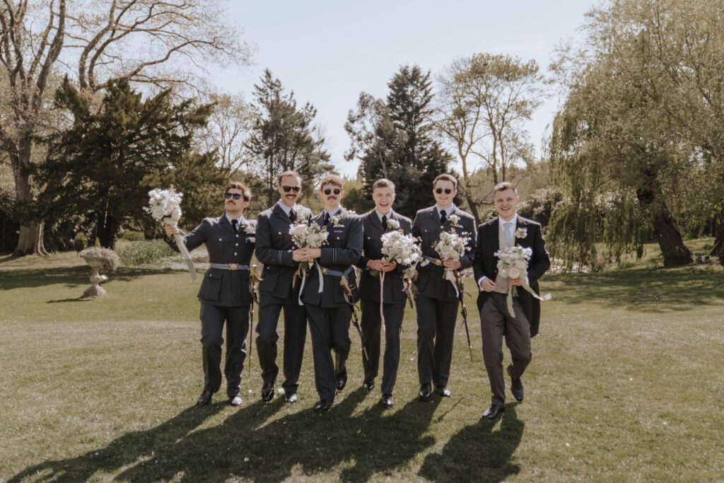 Fun formal photos taken during the drinks reception at a wedding at Seckford Hall