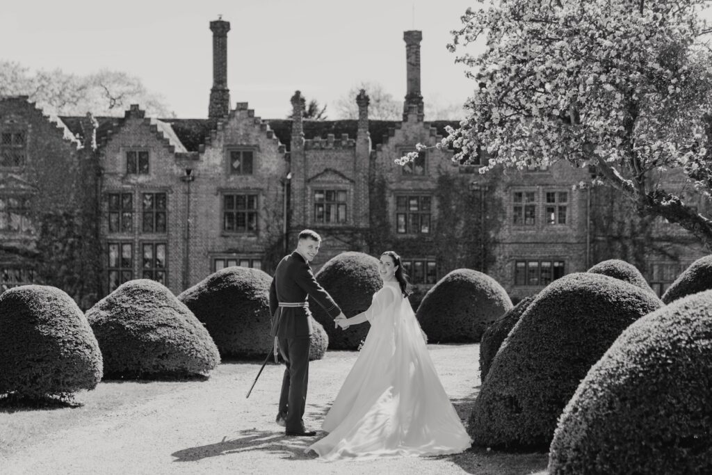 Couples portraits taken of a bride and groom on their wedding day outside Seckford Hall