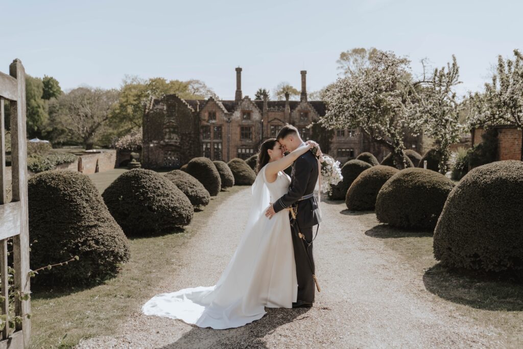 Couples portraits taken of a bride and groom on their wedding day outside Seckford Hall in Suffolk