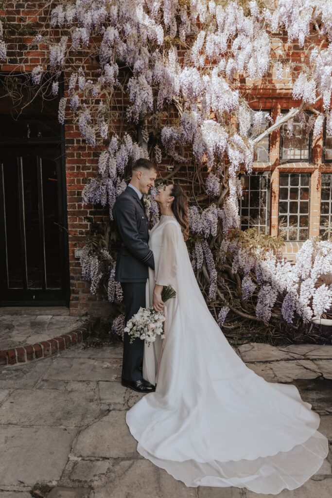 Couples portraits taken of a bride and groom on their wedding day outside Seckford Hall