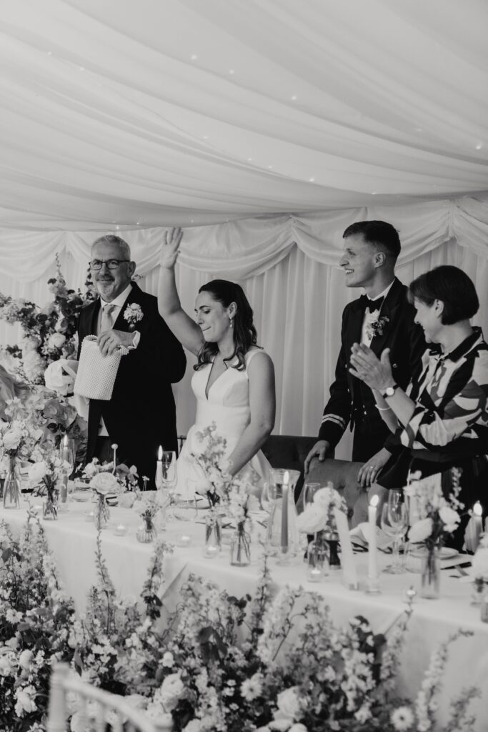 Bride and groom entering wedding reception at Seckford Hall