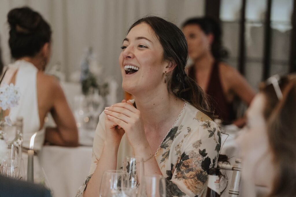 Candid moments of wedding guests during speeches at Seckford Hall