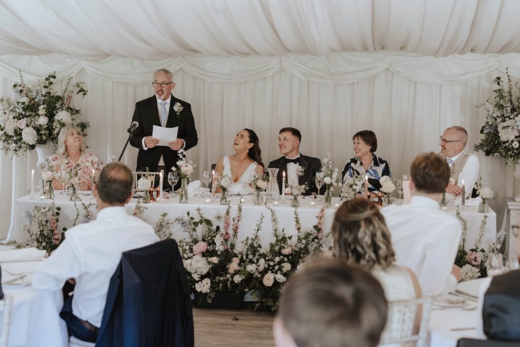 Candid moments of wedding guests during speeches at Seckford Hall