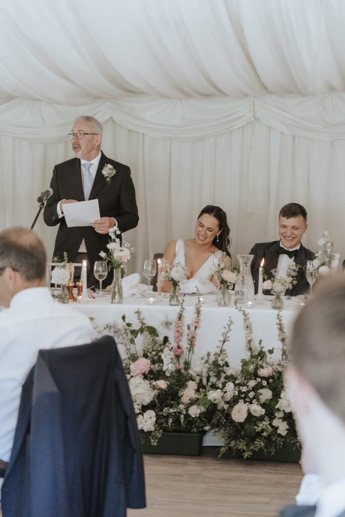 Candid moments of wedding guests during speeches at Seckford Hall