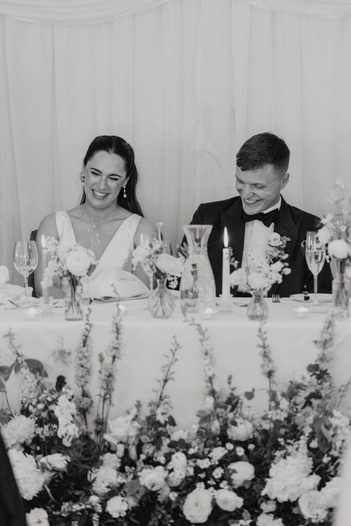 Candid moments of a bride and groom guests during speeches at Seckford Hall