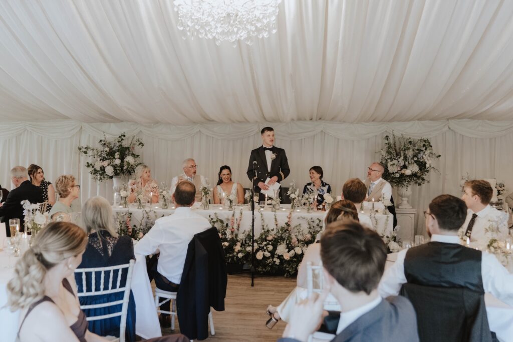 Candid moments of wedding guests during speeches at Seckford Hall