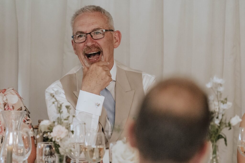 Candid moments of wedding guests during speeches at Seckford Hall