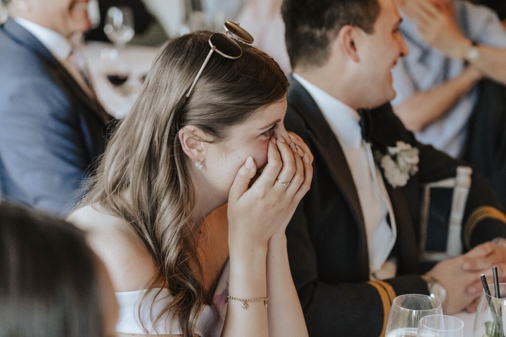 Candid moments of wedding guests during speeches at Seckford Hall