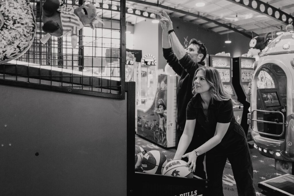Suffolk engagement photographer capturing a couple at an arcade in Felixstowe