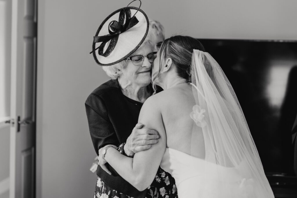 Emotional first look with family of bride during morning prep at Dunglass Estate