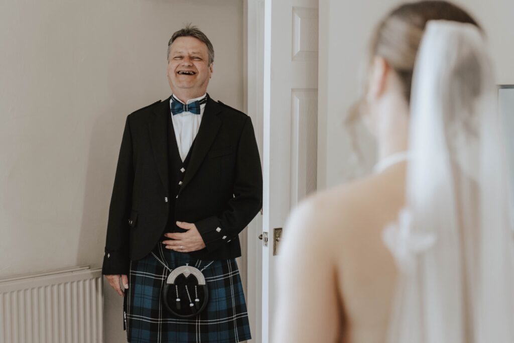 First look with bride and father at Dunglass Estate in Scotland
