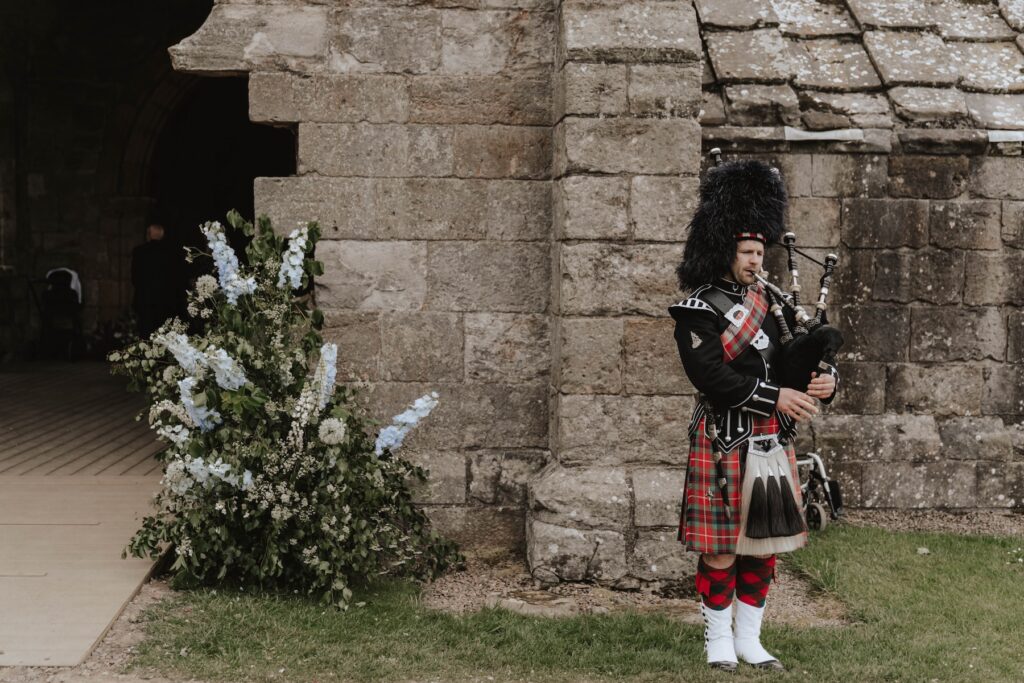 Bagpiper ready for wedding ceremony at Dunglass Estate