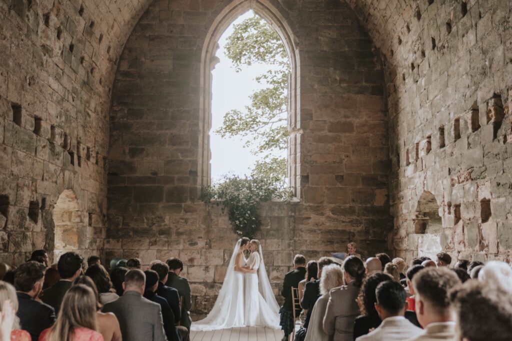 Brides seeing each other during their wedding ceremony in Scotland