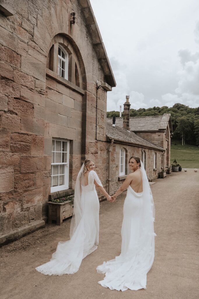 Brides walking together at Dunglass Estate wedding venue